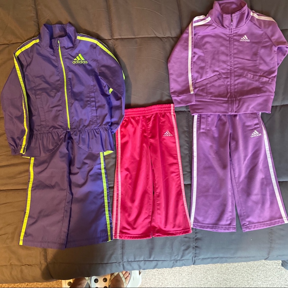 Two adidas suits and a pair of jogger pants.